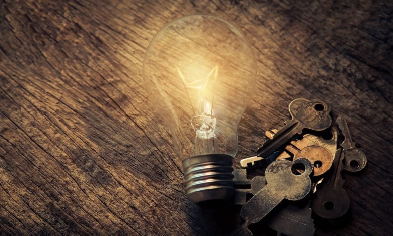 light bulb and keys on table