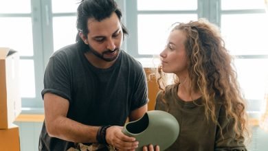 young focused spouses discussing while preparing for relocation