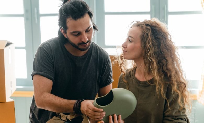 young focused spouses discussing while preparing for relocation