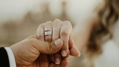 unrecognizable wedding couple holding hands